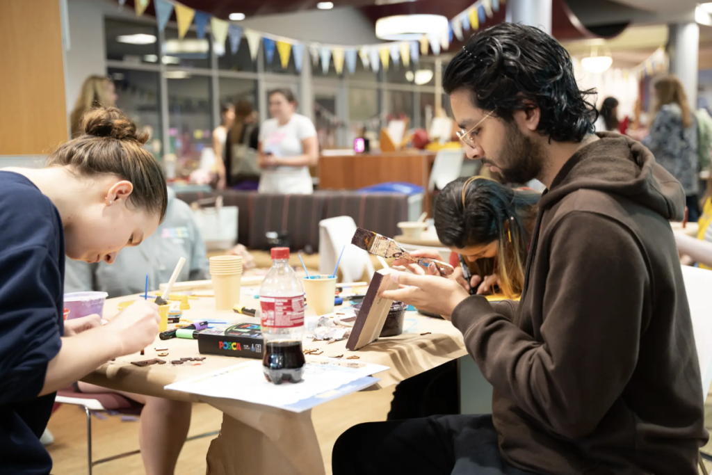 Student making a craft at Takeover 2025